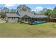 A home with a screened-in pool area, connecting seamlessly with the backyard and the house's architectural details at 1134 Glenwood Rd, Deland, FL 32720