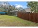 A screened pool area with wood fence for privacy, connecting the home to the outdoors at 1134 Glenwood Rd, Deland, FL 32720