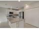Modern kitchen with granite island, stainless steel appliances, and ample storage at 124 Appian Way, Kissimmee, FL 34758