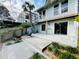 Backyard patio with spiral staircase, upper deck, landscaping and mature trees, providing a private outdoor living area at 124 Godfrey Rd, Edgewater, FL 32141
