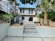 Backyard patio with landscaping, a second story porch with railings and a spiral staircase, offering a private and scenic outdoor space at 124 Godfrey Rd, Edgewater, FL 32141