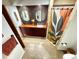 Updated bathroom featuring dual mirrors, tiled accent wall, and updated shower at 124 Godfrey Rd, Edgewater, FL 32141