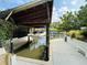 A covered boat dock on the water provides shelter, and includes a boat resting in a lift, enhancing the property's waterfront appeal at 124 Godfrey Rd, Edgewater, FL 32141