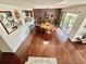 Open-concept living space with hardwood floors, a dining area, and a kitchen in the background at 124 Godfrey Rd, Edgewater, FL 32141