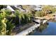 Waterfront house with a private boat lift and dock, surrounded by lush greenery at 124 Godfrey Rd, Edgewater, FL 32141