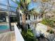 An inviting view of a lovely home with a pool, patio, and charming spiral staircase, surrounded by lush greenery at 124 Godfrey Rd, Edgewater, FL 32141