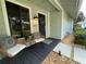 Welcoming front porch with stylish furniture and decor near the front door at 124 Godfrey Rd, Edgewater, FL 32141
