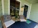 Inviting front porch with stylish chairs and decorations for curb appeal at 124 Godfrey Rd, Edgewater, FL 32141