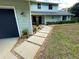 Attractive home exterior with rock and paver walkway that leads to the front door at 124 Godfrey Rd, Edgewater, FL 32141