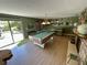 Entertain guests in this room with a billiard table, a stone fireplace and bar area at 124 Godfrey Rd, Edgewater, FL 32141
