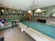 Entertain guests in this room with a billiard table, a stone fireplace and bar area at 124 Godfrey Rd, Edgewater, FL 32141