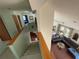 Hallway with carpet, light-green walls, and a view of the living room at 124 Godfrey Rd, Edgewater, FL 32141