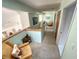 Upstairs hallway featuring carpet, light-green walls, and access to other rooms at 124 Godfrey Rd, Edgewater, FL 32141