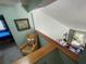 Upstairs hallway features a skylight, chair, and view of the living room at 124 Godfrey Rd, Edgewater, FL 32141