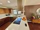 Modern kitchen with stainless steel appliances, a breakfast bar, and wood cabinets at 124 Godfrey Rd, Edgewater, FL 32141