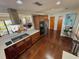 Spacious kitchen with stainless appliances, wooden cabinets, and an open view to the dining and living area at 124 Godfrey Rd, Edgewater, FL 32141