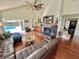 Bright living room with a fireplace, hardwood floors, and a ceiling fan with access to the pool area at 124 Godfrey Rd, Edgewater, FL 32141