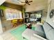 Cozy sunroom featuring wood-paneled walls, a comfortable couch, a wet bar, and seamless access to the pool at 124 Godfrey Rd, Edgewater, FL 32141