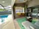 Inviting sunroom with a wet bar, comfortable seating, and an easy transition to the pool area for relaxation and entertainment at 124 Godfrey Rd, Edgewater, FL 32141