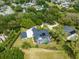 An aerial view of a stunning estate with a large home, screened pool and separate garage at 1312 Winter Springs Blvd, Winter Springs, FL 32708