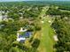 This aerial view of the property shows the manicured golf course and beautiful tree coverage at 1312 Winter Springs Blvd, Winter Springs, FL 32708