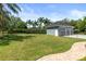 A sprawling backyard with lush lawn and well-maintained landscaping with a three car detached garage at 1312 Winter Springs Blvd, Winter Springs, FL 32708