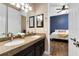 Bright bathroom with dual sinks and granite counters located just off a bedroom at 1312 Winter Springs Blvd, Winter Springs, FL 32708