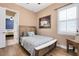 Well-lit bedroom with wood-look floors, a queen bed, and natural light from the window at 1312 Winter Springs Blvd, Winter Springs, FL 32708