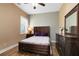 Cozy bedroom featuring wood-look floors, a unique headboard, and plenty of natural light at 1312 Winter Springs Blvd, Winter Springs, FL 32708