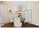 Elegant dining room with hardwood floors, modern chandelier, and bright, natural lighting at 1312 Winter Springs Blvd, Winter Springs, FL 32708