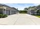 Spacious driveway offering ample parking space with garages on either side of the property in grey paint at 1312 Winter Springs Blvd, Winter Springs, FL 32708