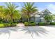 Charming single-story home featuring mature palm trees, a lush yard and a circular driveway at 1312 Winter Springs Blvd, Winter Springs, FL 32708