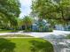 Beautiful single-story home with lush landscaping, palm trees and a spacious circular driveway at 1312 Winter Springs Blvd, Winter Springs, FL 32708