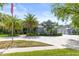 A view of a lovely home, its driveway and three car garage with palm trees in the front yard at 1312 Winter Springs Blvd, Winter Springs, FL 32708