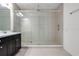 Modern bathroom features tiled shower, glass doors, and vanity sink at 14214 Shocklach Dr, Winter Garden, FL 34787