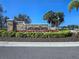 Stone community entrance sign surrounded by colorful landscaping and lush greenery in a serene setting at 14214 Shocklach Dr, Winter Garden, FL 34787