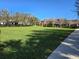 Expansive community park with lush green lawn, mature trees, and nearby homes at 14214 Shocklach Dr, Winter Garden, FL 34787