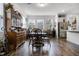 Cozy dining room with wooden floors, three windows, and decorative hutch at 14214 Shocklach Dr, Winter Garden, FL 34787