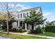 Charming two-story home features blue shutters, manicured landscaping, and inviting front porch with seating at 14214 Shocklach Dr, Winter Garden, FL 34787