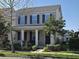 Charming two-story home with a cozy front porch, white pillars, and manicured landscaping at 14214 Shocklach Dr, Winter Garden, FL 34787