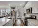 Well lit kitchen with white cabinets, stainless steel appliances, tile backsplash, and laminate flooring at 14214 Shocklach Dr, Winter Garden, FL 34787