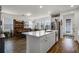Open-concept kitchen and dining area with island, white cabinets, and stainless steel appliances at 14214 Shocklach Dr, Winter Garden, FL 34787