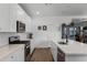 Bright kitchen features white cabinets, stainless steel appliances, subway tile backsplash, and island with sink at 14214 Shocklach Dr, Winter Garden, FL 34787