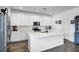 Bright kitchen featuring island with sink, white cabinets, subway tile backsplash, and stainless steel appliances at 14214 Shocklach Dr, Winter Garden, FL 34787