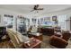 Inviting living room with hardwood floors, a ceiling fan, and a display case at 14214 Shocklach Dr, Winter Garden, FL 34787