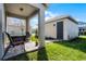 Covered patio features a brick floor with seating, plus view of the shed and well-manicured lawn at 14214 Shocklach Dr, Winter Garden, FL 34787