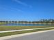 Picturesque pond surrounded by lush greenery and a charming white fence, enhancing the community's natural beauty at 14214 Shocklach Dr, Winter Garden, FL 34787