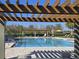 An inviting pool is framed by a decorative pergola and offers plenty of poolside seating at 14214 Shocklach Dr, Winter Garden, FL 34787