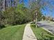 Well-maintained sidewalk lined with trees, offering a safe and inviting space for pedestrians in the community at 14214 Shocklach Dr, Winter Garden, FL 34787