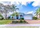 Charming light blue home featuring a well-manicured front yard and an attached two-car garage at 1431 Twin Rivers Blvd, Oviedo, FL 32766